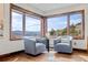 Bright sitting area features a cozy corner with armchairs and stunning mountain views from large windows at 2063 Montane E Dr, Golden, CO 80401