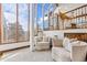 Cozy sitting area boasts floor-to-ceiling windows, wood trim, and mountain views at 2063 Montane E Dr, Golden, CO 80401