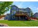 Two-story house with a wood deck, a small shed and lush green lawn at 879 Quintana Ln, Erie, CO 80516