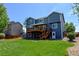 Two-story house with a backyard featuring a wood deck and lush green lawn at 879 Quintana Ln, Erie, CO 80516