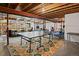Spacious basement featuring open ceilings, rubber flooring, and a ping pong table for Gathering entertainment at 879 Quintana Ln, Erie, CO 80516