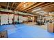 Unfinished basement area with open ceiling, rubber flooring, and plenty of room for activities or storage at 879 Quintana Ln, Erie, CO 80516