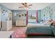 bedroom featuring blue walls, a pink rug, and decorative wall vines at 879 Quintana Ln, Erie, CO 80516