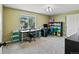 Bright, carpeted room featuring a work space, shelves, and a large window at 879 Quintana Ln, Erie, CO 80516