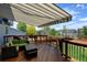 Outdoor deck perfect for entertaining, with shade awning and outdoor seating at 879 Quintana Ln, Erie, CO 80516