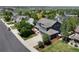 Beautiful two-story home features an attached garage, mature trees, a cozy front porch, and a well-manicured lawn at 879 Quintana Ln, Erie, CO 80516