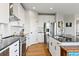 Modern kitchen with white cabinets, stainless steel appliances, and granite countertops at 879 Quintana Ln, Erie, CO 80516