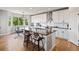 Eat-in kitchen boasts white cabinets, an island with seating, and natural light at 879 Quintana Ln, Erie, CO 80516