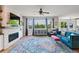 Bright living room with a fireplace, large windows, and a colorful area rug at 879 Quintana Ln, Erie, CO 80516