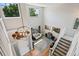 Bright living room with soaring ceilings, hardwood floors, and abundant natural light from large windows at 879 Quintana Ln, Erie, CO 80516
