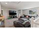 Spacious upstairs living area with plush carpeting, and an oversized black leather sofa for comfortable lounging at 879 Quintana Ln, Erie, CO 80516