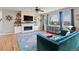Cozy living room with stone fireplace, bright windows, and comfortable seating at 879 Quintana Ln, Erie, CO 80516