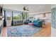 Bright living area with hardwood floors, large windows, and an open layout to the kitchen at 879 Quintana Ln, Erie, CO 80516