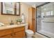 Updated bathroom features a vanity with a granite countertop, a glass-enclosed shower and new fixtures at 2173 S Ouray St, Aurora, CO 80013