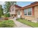 Charming home featuring a well-maintained lawn, solar panels, and a walkway leading to the front door at 2173 S Ouray St, Aurora, CO 80013