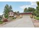 Charming home featuring a well-maintained lawn, solar panels, and a large driveway leading to a two-car garage at 2173 S Ouray St, Aurora, CO 80013