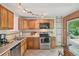 Well-equipped kitchen with wood cabinets, stainless steel appliances, and lots of light at 2173 S Ouray St, Aurora, CO 80013