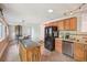 Well-equipped kitchen with wood cabinets, stainless steel appliances, and an island prep area at 2173 S Ouray St, Aurora, CO 80013