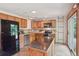 Well-equipped kitchen with wood cabinets, stainless steel appliances, and a center island at 2173 S Ouray St, Aurora, CO 80013