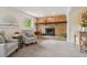 Cozy living room with a brick fireplace, plush carpet, and comfortable seating at 2173 S Ouray St, Aurora, CO 80013