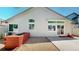 Backyard featuring a neutral-colored home exterior, wooden planter, and a concrete patio at 2225 S Lima Ct, Aurora, CO 80014