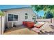 Backyard featuring a neutral-colored home exterior, wooden planter, and a concrete patio at 2225 S Lima Ct, Aurora, CO 80014
