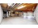 Spacious unfinished basement with visible utilities, concrete flooring and two windows providing natural light at 2225 S Lima Ct, Aurora, CO 80014