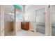 Bathroom featuring granite counters, tiled floors, and a glass-enclosed shower at 2225 S Lima Ct, Aurora, CO 80014
