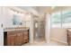 Bathroom featuring granite counters, tiled floors, and glass enclosed shower at 2225 S Lima Ct, Aurora, CO 80014