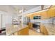 Well-lit kitchen features granite counters, stainless steel appliances, and ample storage space at 2225 S Lima Ct, Aurora, CO 80014