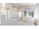 Spacious living room featuring neutral carpet, a large window, and access to other rooms at 2225 S Lima Ct, Aurora, CO 80014
