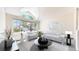 Bright living room with large windows, vaulted ceiling, and modern, minimalist decor at 2225 S Lima Ct, Aurora, CO 80014