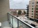 A balcony view of Sloan's Lake, with outdoor seating, a street view, and a nearby building at 4200 W 17Th Ave # 411, Denver, CO 80204
