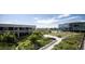 Lush community garden with walkways, greenery, and contemporary buildings under a sunny sky at 4200 W 17Th Ave # 411, Denver, CO 80204