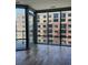 Empty room with hardwood floors and a large window overlooking a brick building at 4200 W 17Th Ave # 411, Denver, CO 80204
