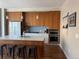 Modern kitchen with wood cabinets, sleek island, stainless steel appliances, and pendant lighting at 4200 W 17Th Ave # 411, Denver, CO 80204