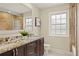 Bathroom with tiled floors, shower, double sinks, and granite counters at 5708 S Galena St, Greenwood Village, CO 80111