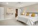 Bright bedroom featuring carpeted floors, a ceiling fan, ensuite bathroom and neutral paint at 5708 S Galena St, Greenwood Village, CO 80111