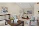 Open-concept living room with a dining area featuring a glass table and elegant white chairs at 5708 S Galena St, Greenwood Village, CO 80111