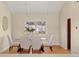 Cozy dining area with a glass table, white chairs, and hardwood flooring at 5708 S Galena St, Greenwood Village, CO 80111