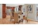 Cozy dining area with hardwood floors, stylish wicker chairs, and a view into the adjacent kitchen at 5708 S Galena St, Greenwood Village, CO 80111