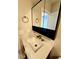 Modern bathroom vanity featuring gold faucet, stylish mirror, and contemporary design at 1435 N Uinta St, Denver, CO 80220
