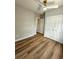 Cozy bedroom featuring modern ceiling fan, hardwood floors, and closet space at 1435 N Uinta St, Denver, CO 80220