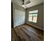 Well-lit bedroom with wood floors, a closet, and large windows at 1435 N Uinta St, Denver, CO 80220