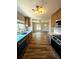 Modern kitchen boasts stainless steel appliances, light countertops, and wood-look flooring at 1435 N Uinta St, Denver, CO 80220