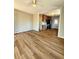 Open-concept living room features hardwood flooring and views of the updated kitchen at 1435 N Uinta St, Denver, CO 80220