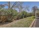 Backyard featuring green lawn surrounded by lush trees and plants at 1737 Jules Ct, Highlands Ranch, CO 80126