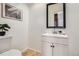 Well-lit half bathroom features a modern single sink vanity and artwork at 1737 Jules Ct, Highlands Ranch, CO 80126