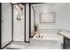 Bright bathroom showcases white tile, gold fixtures, and a glass-enclosed shower at 1737 Jules Ct, Highlands Ranch, CO 80126