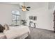 Bright primary bedroom features gray carpeting, fan, and a sliding door to the balcony at 1737 Jules Ct, Highlands Ranch, CO 80126